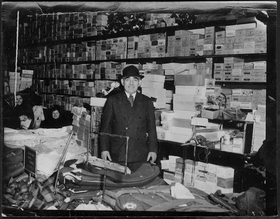 a man standing in a room full of boxes.