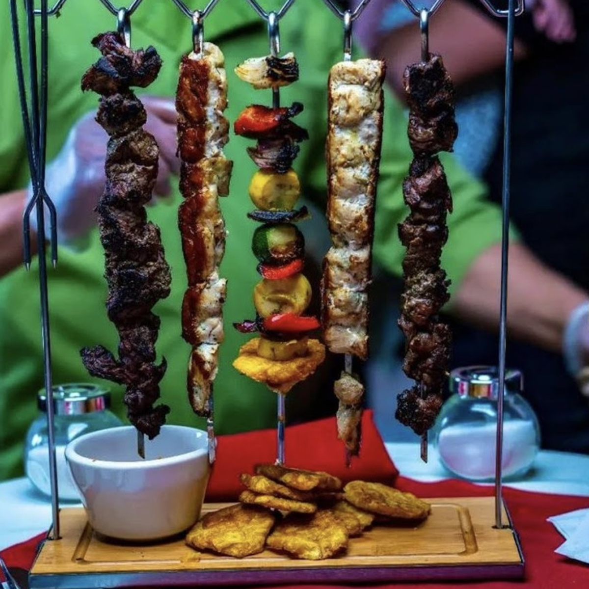 a bunch of skewers of food on a table.