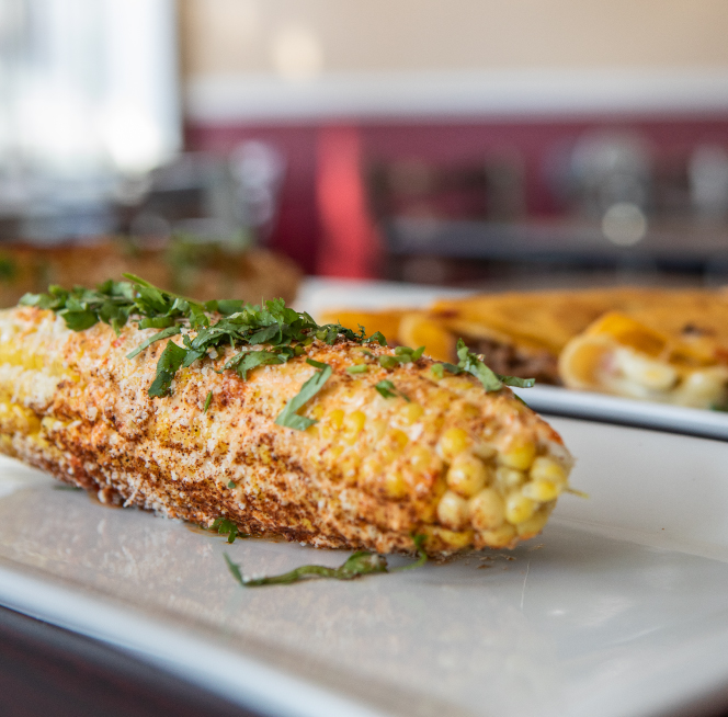 corn on the cob on a white plate.