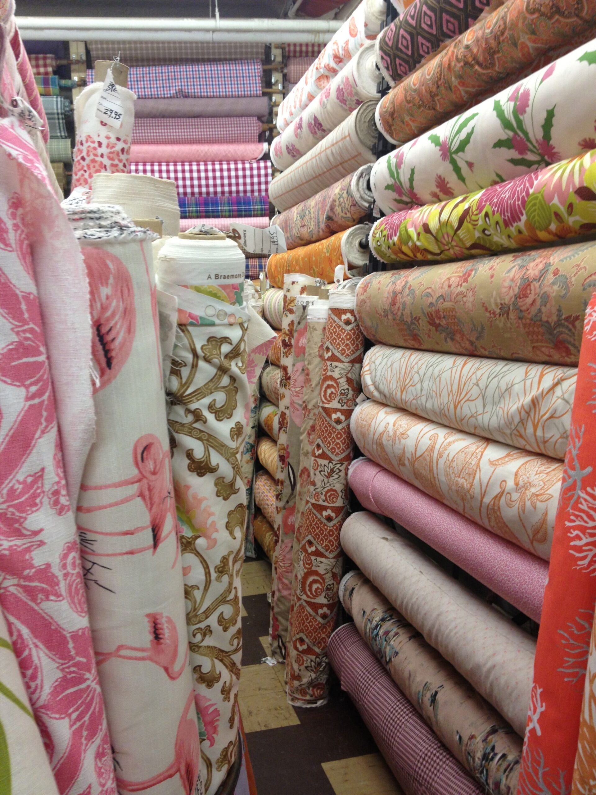 a store filled with lots of different colored fabrics.