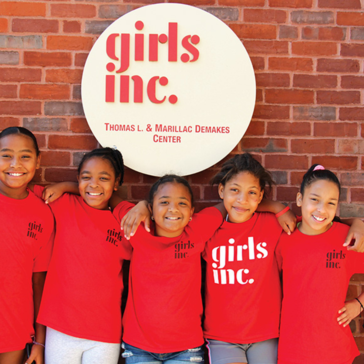 a group of young girls standing next to each other.