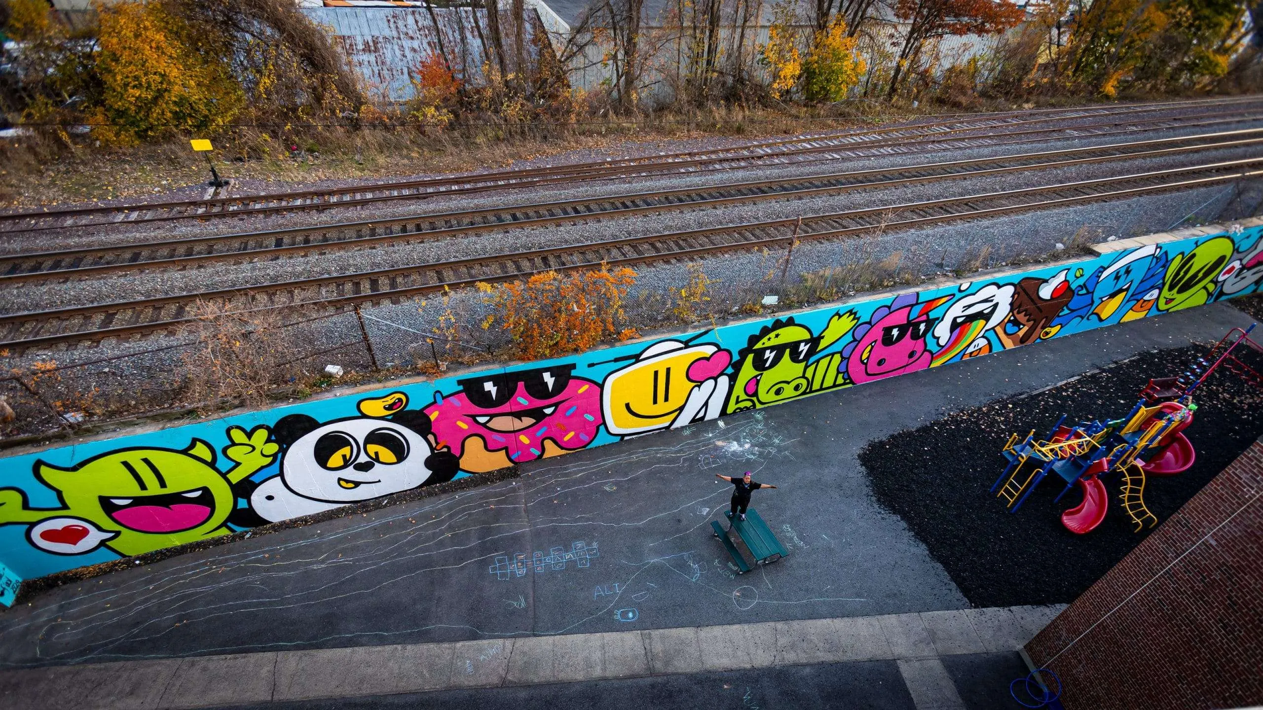 a train track with graffiti on the side of it.
