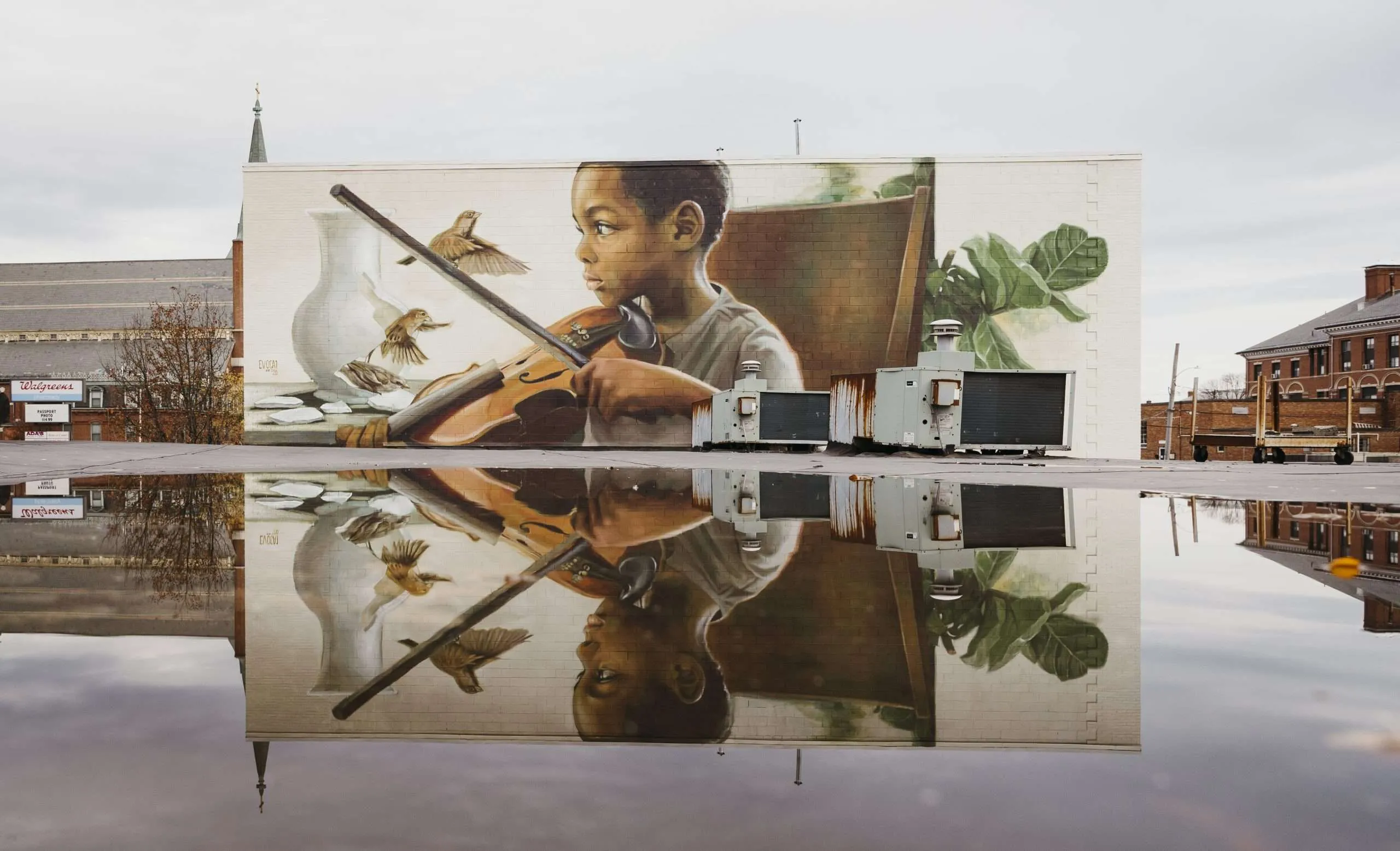 a mural of a boy playing a violin.