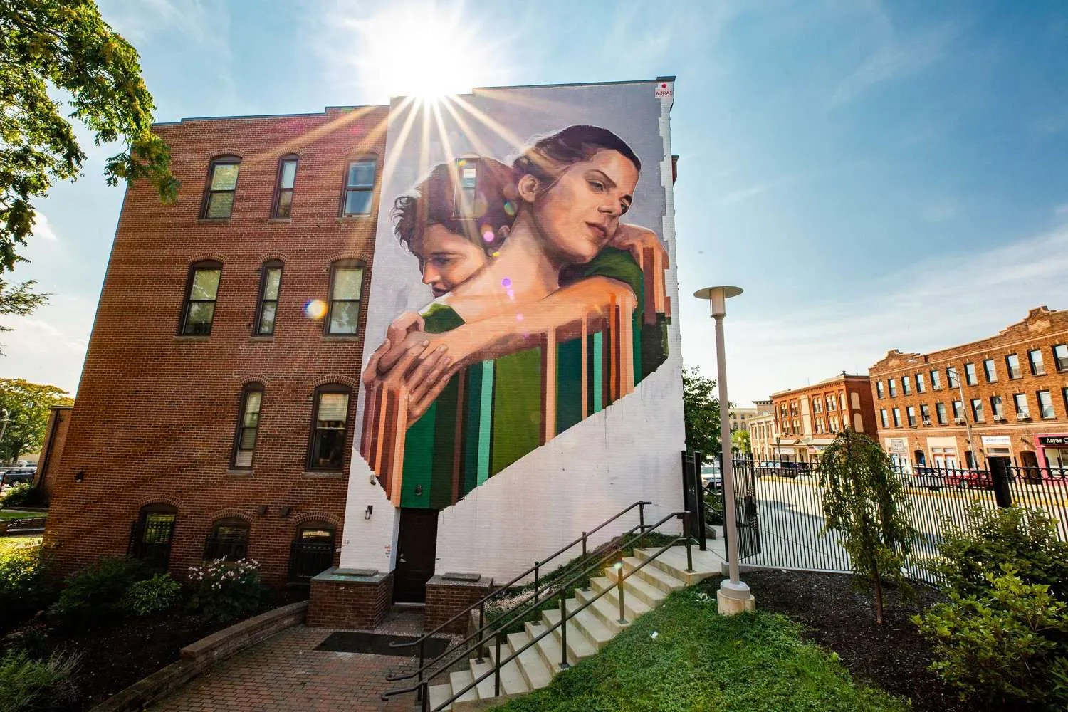a large mural of a woman holding a child on the side of a building.