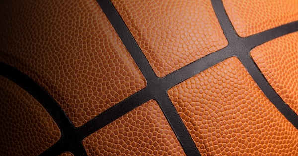 a close up image of a basketball on a black background.