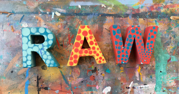 the word raw is painted on a colorful background.