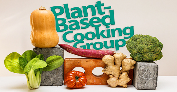 An assortment of fresh vegetables—like butternut squash, broccoli, bok choy, sweet potatoes, ginger, and a tomato—are artfully placed on and around bricks. In the background, you’ll see the words "Plant-Based Cooking Group.