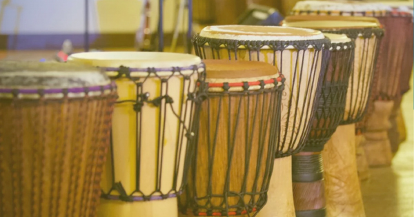 A vibrant lineup of traditional African drums showcases their unique designs and rich colors.