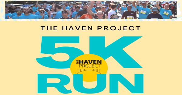Smiling racers in blue shirts unite at the start of The Haven Project 5K, celebrating Essex County’s vibrant community spirit.