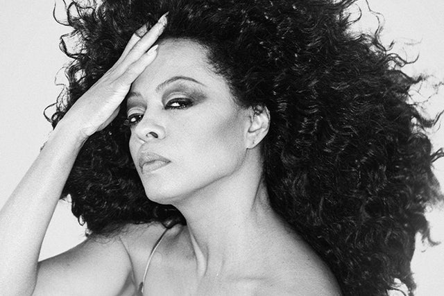 Dynamic black and white portrait of a creative woman with bold curls, inspiring Essex County with her thoughtful, connected gaze.