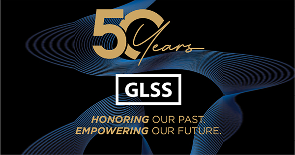 Gold text reads "50 Years," with "GLSS" in a white box below. White and gold text underneath says, "Honoring our past, empowering our future," on a black background with abstract blue wave patterns.