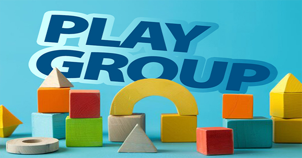 Colorful wooden blocks, including cubes, arches, and pyramids, are arranged on a blue surface in front of a blue background. The words "PLAY GROUP" appear in bold, blue letters at the top of the image.