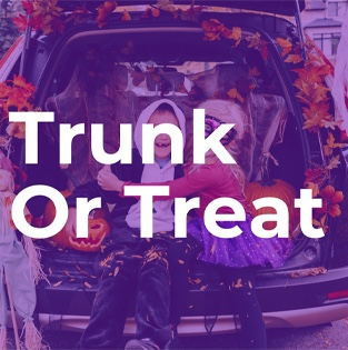 Two children in Halloween costumes sit inside the decorated trunk of a car with the text “Trunk Or Treat” overlaid.