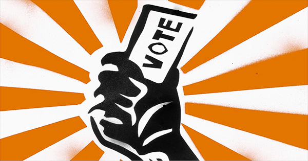 A stylized black fist raised against an orange and white sunburst background, holding a ballot marked with the word “VOTE.”
